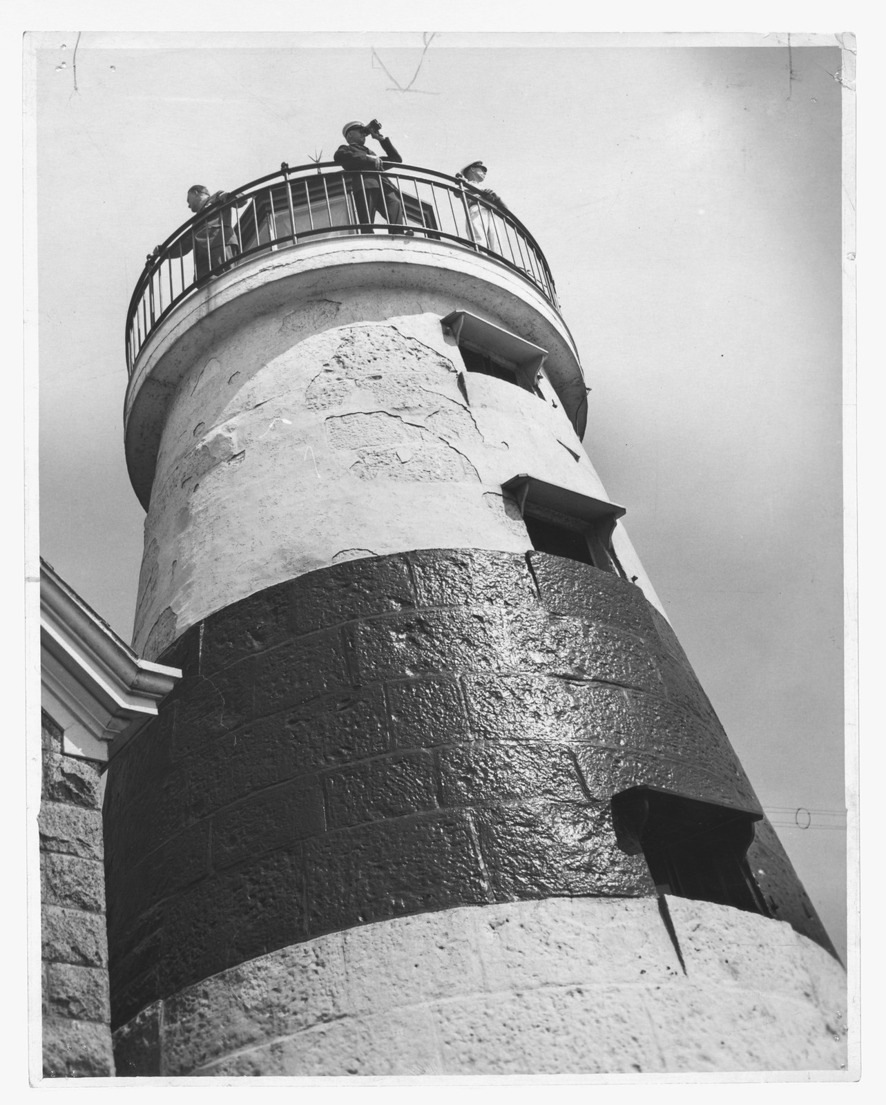 Lighthouse tower with two observers on the gallery balcony — historic image