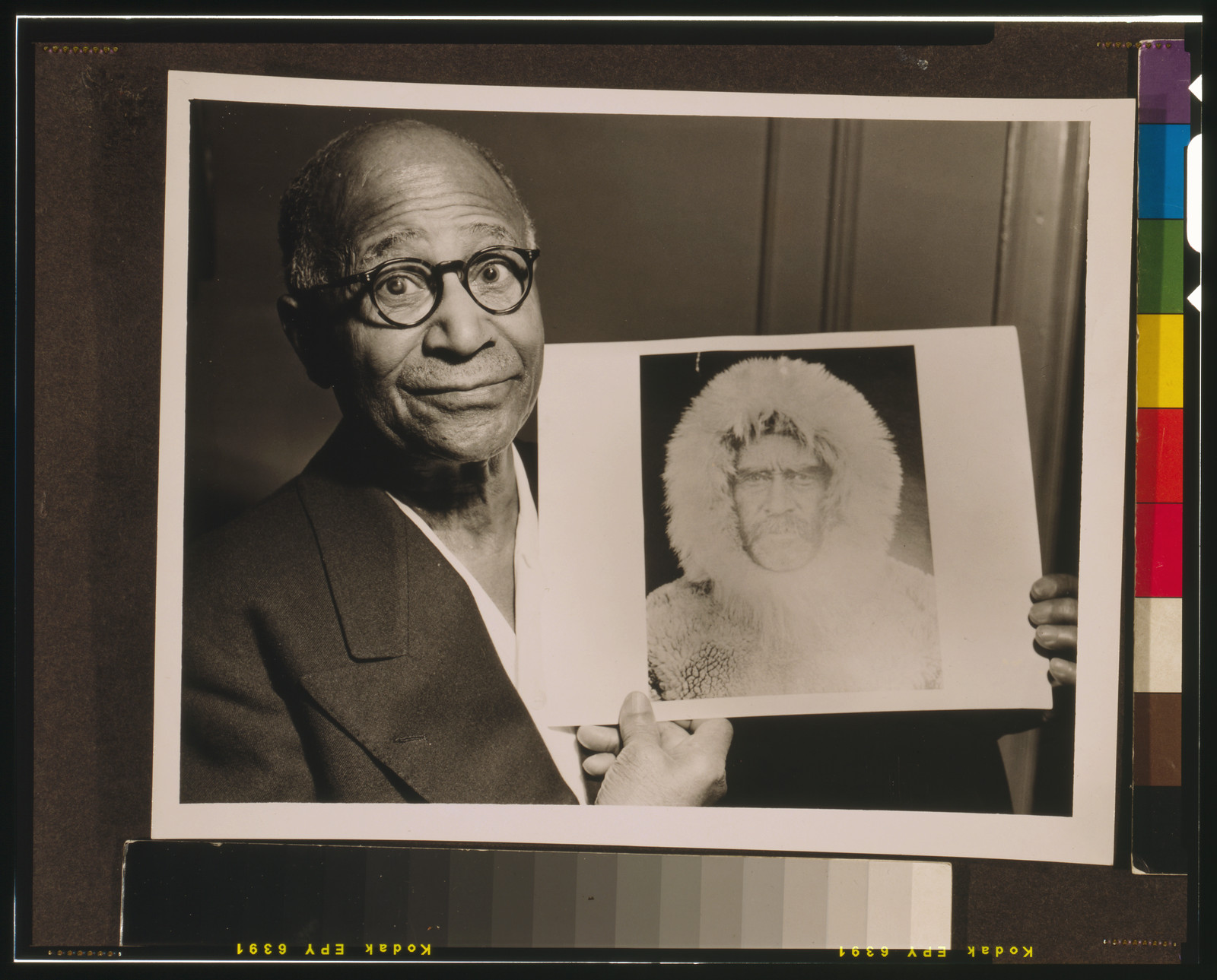 [Matthew Henson, head-and-shoulders portrait, facing front, holding a portrait of Robert E. Peary taken during an expedition to the North Pole] / World-Telegram photo by Roger Higgins., 1953 — historic photograph