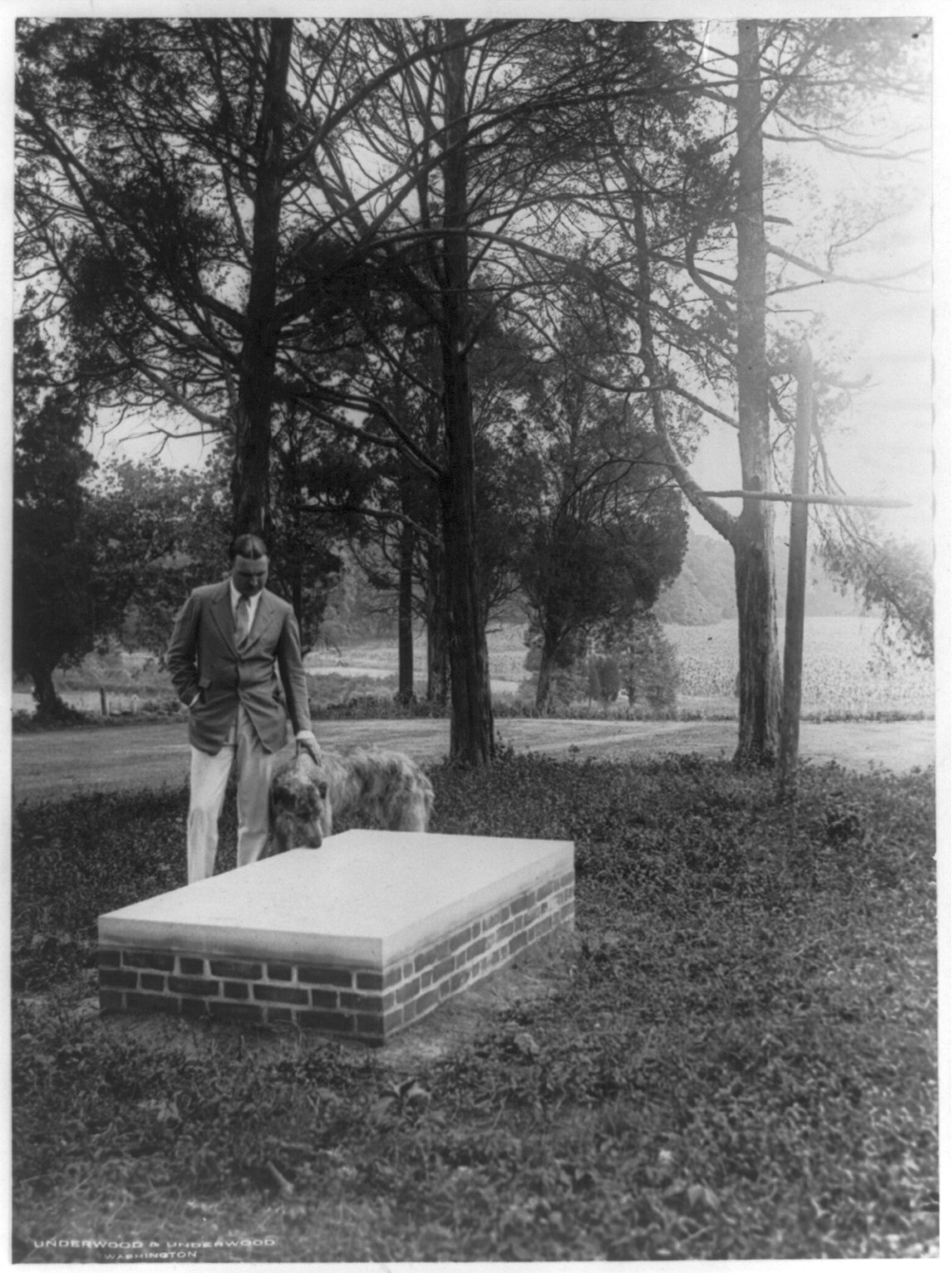 [E. Francis Riggs standing by stone slab which he had erected in honor of Pierre Charles L'Enfant], 1925 July. — historic photograph