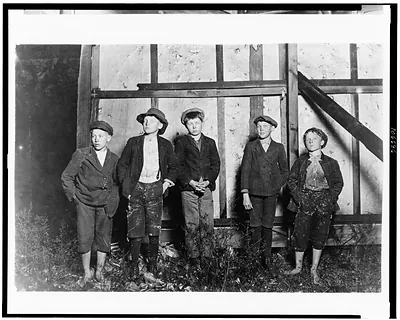 Flashlight photos of 5 boys who work in Augusta (Ga.) cotton mill. Supt. refused to let me go through the mill so I went there at 6 P.M. and under cover of darkness got these boys as they came out. Then we went out back of the bill boards and took the photo. 3 of the smallest of there 5 boys been there 3 years. 1 other for 4 yrs. Many children in this mill. I saw about 25 boys & girls from 9 to 14