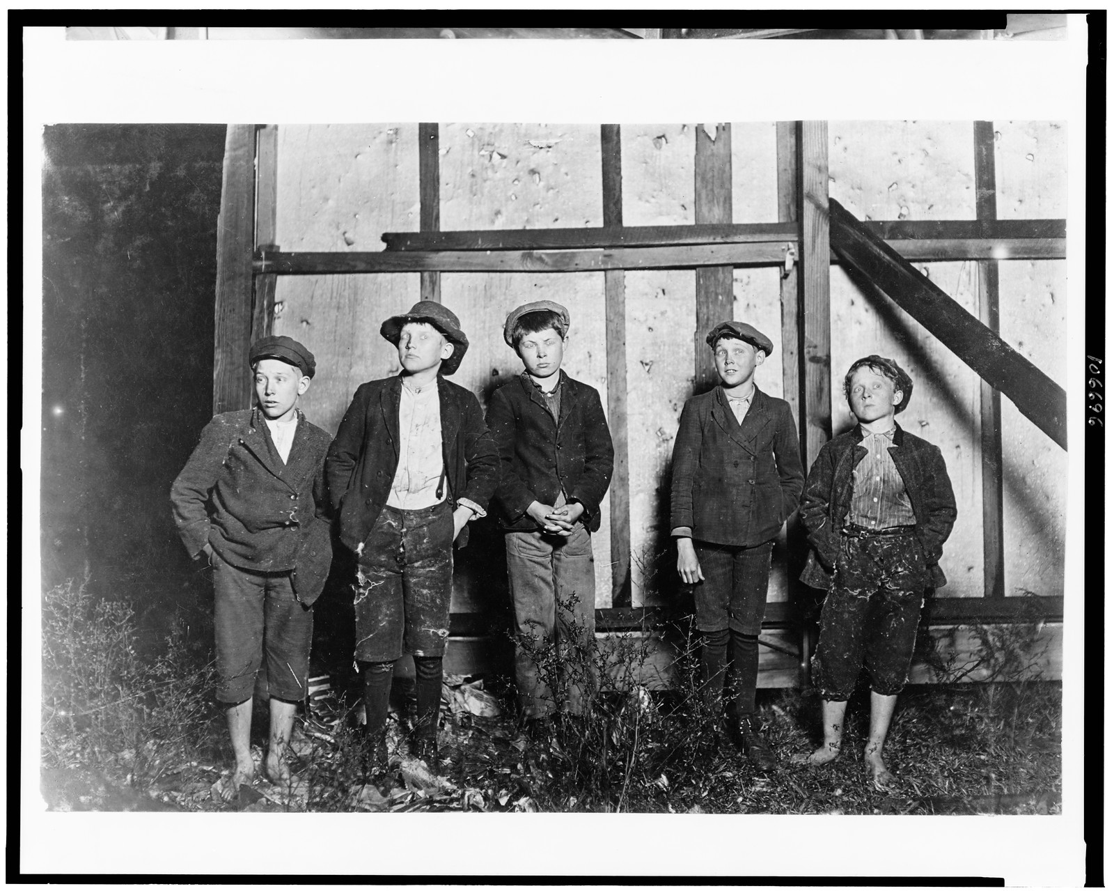 Flashlight photos of 5 boys who work in Augusta (Ga.) cotton mill. Supt. refused to let me go through the mill so I went there at 6 P.M. and under cover of darkness got these boys as they came out. Then we went out back of the bill boards and took the photo. 3 of the smallest of there 5 boys been there 3 years. 1 other for 4 yrs. Many children in this mill. I saw about 25 boys & girls from 9 to 14, 1909 January 14. — historic photograph