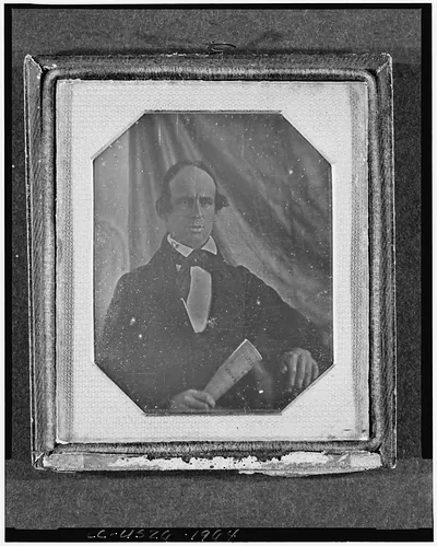 Daguerreotype portrait of a man holding a rolled paper