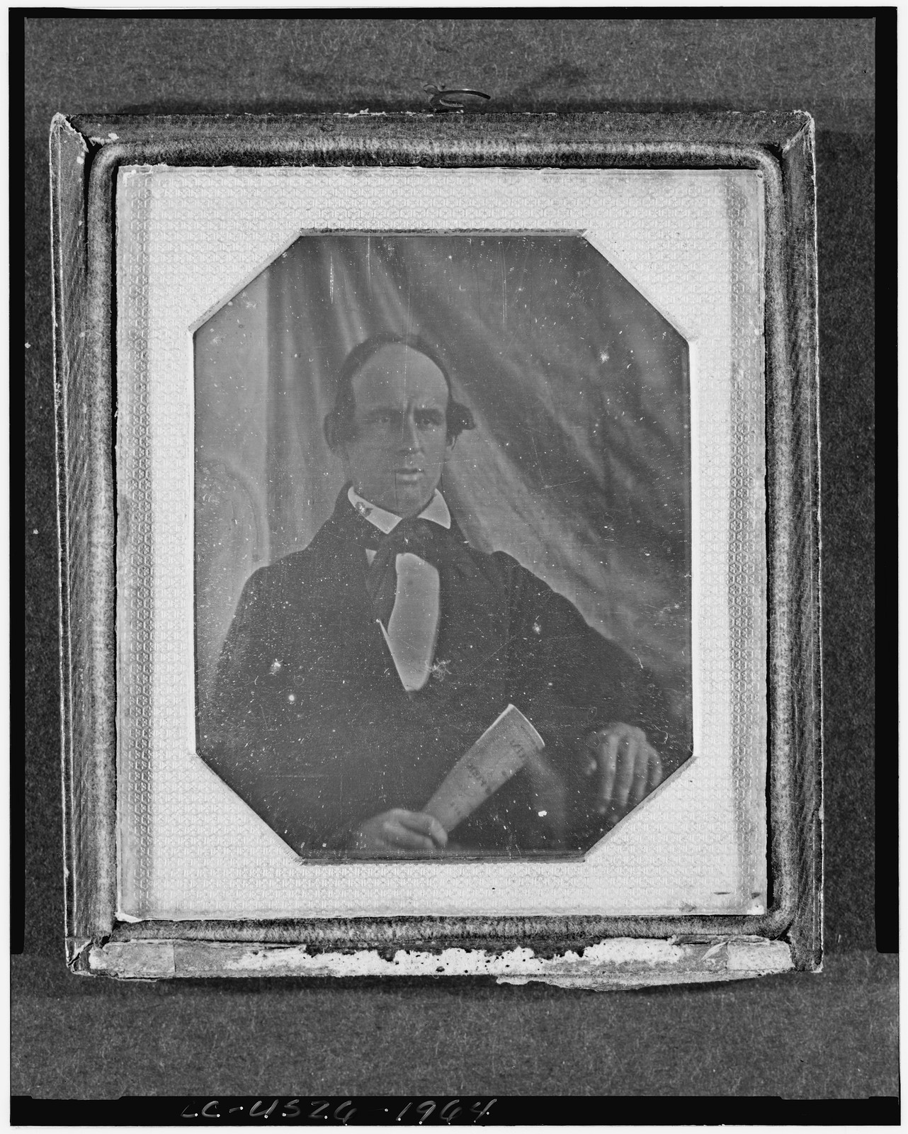 Daguerreotype portrait of a man holding a rolled paper, 1840 — historic photograph