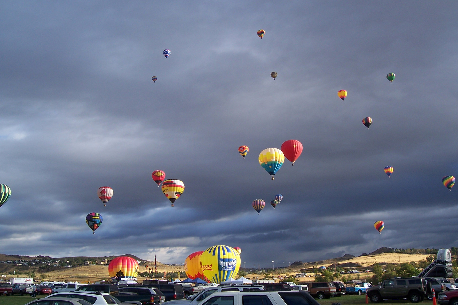 Hot air balloons rising over parking lot at festival — historic image