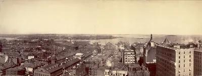 Sepia panoramic view of a harbor city with ships