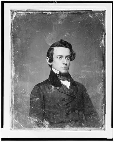 Portrait of a young man in a dark coat