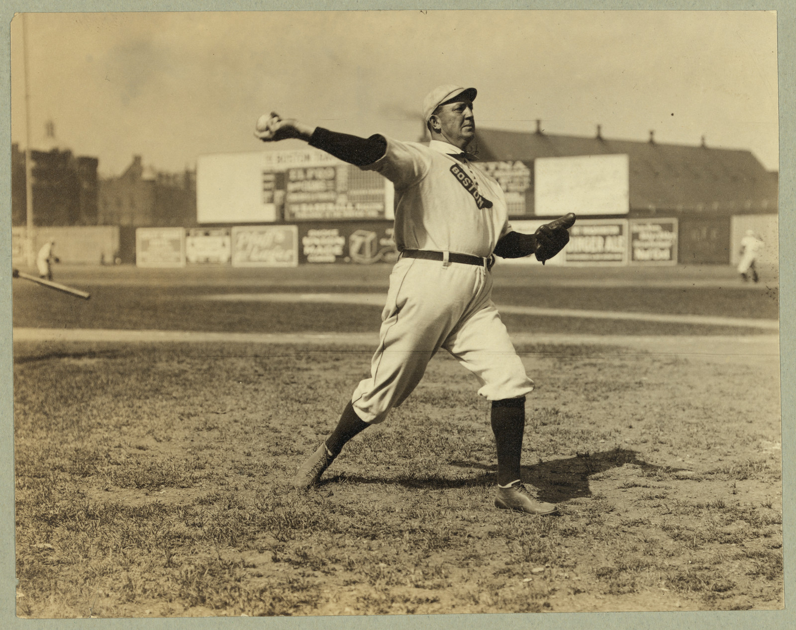 Cy Young, Boston AL, full-length portrait, standing, facing right, throwing baseball, c. 1908 — historic image