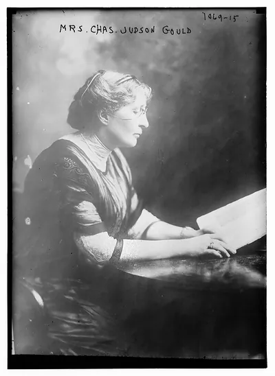 Mrs. Chas. Judson Gould at table with book