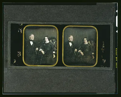 Hand-colored daguerreotype stereo pair of a seated older couple