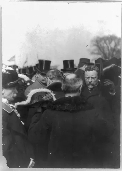 [Theodore Roosevelt, Pres. U.S. receiving congratulations from diplomats; raising hat in crowd]