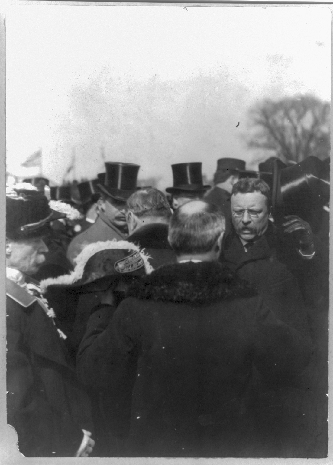 [Theodore Roosevelt, Pres. U.S. receiving congratulations from diplomats; raising hat in crowd] — historic photograph