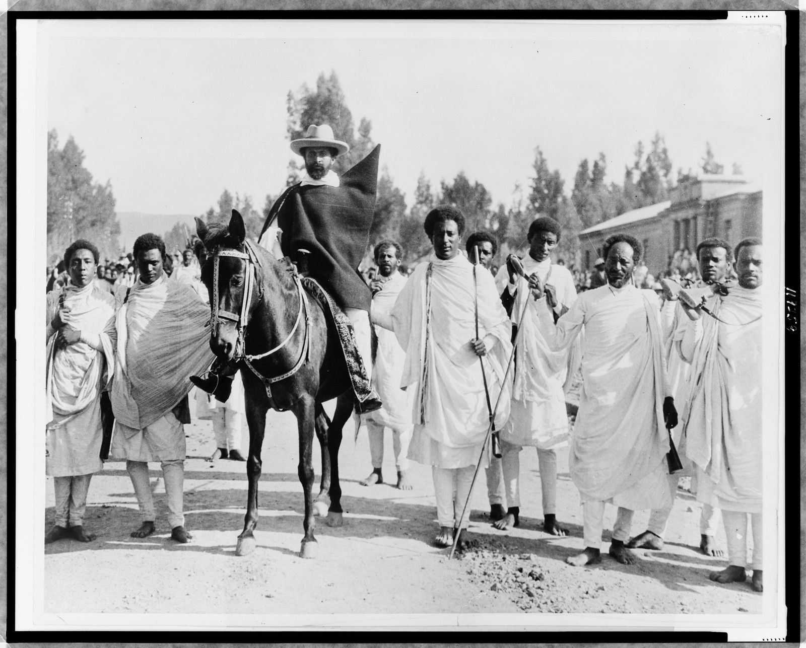 [Haile Selassie on horseback surrounded by bodyguards, Addis Ababa, Ethiopia] — historic photograph