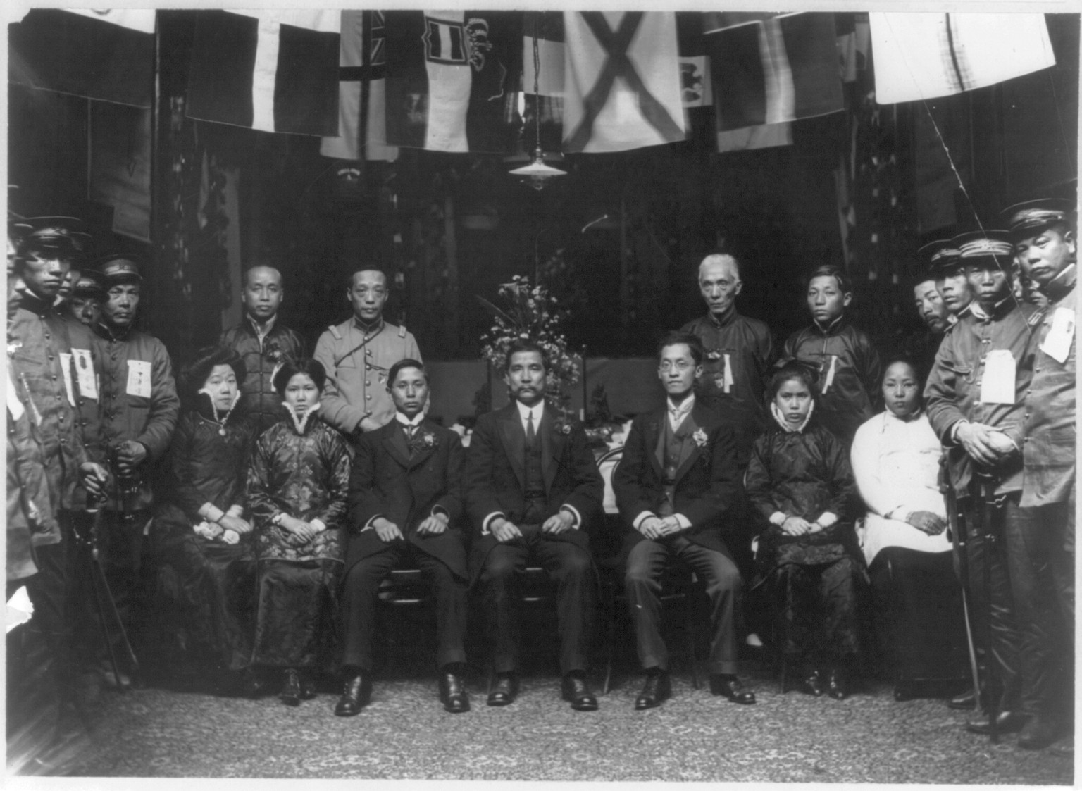 [Sun Yat-sen, 1866-1925, full-length portrait, seated, in middle of large formal group] — historic photograph