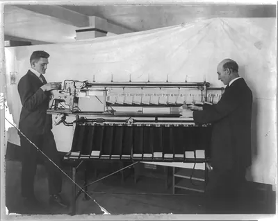 [Two men with automatic card sorting machine used for census taking]