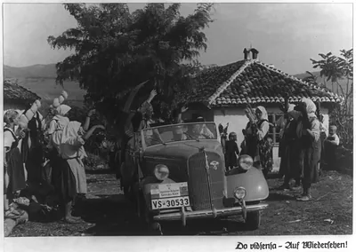 Motor trip through Yugoslavia and Bulgaria by officials of the NSKK (National Socialist Motor Corps) 1937: [Men in Opel convertible waving to peasants at roadside]