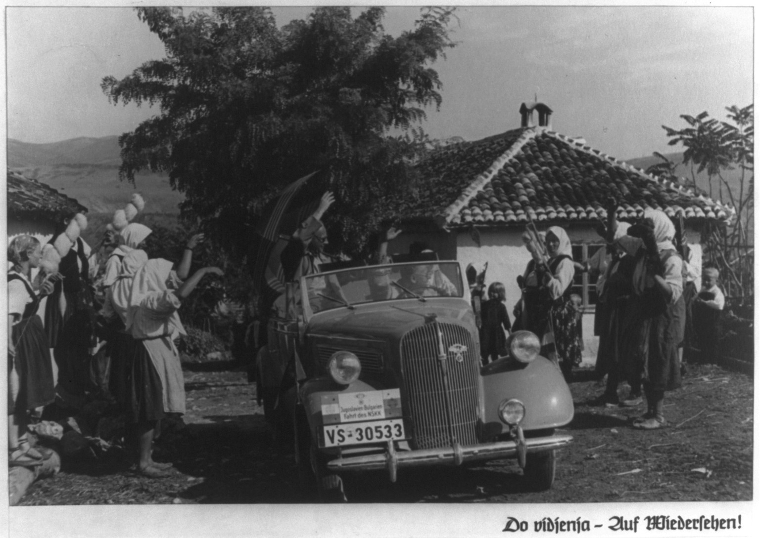 Motor trip through Yugoslavia and Bulgaria by officials of the NSKK (National Socialist Motor Corps) 1937: [Men in Opel convertible waving to peasants at roadside], 1937 — historic photograph