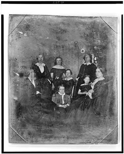 [Unidentified group of six women and a boy and girl, three women and the boy are seated in chairs]