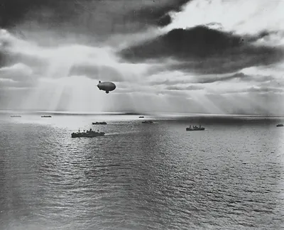 Airship over a convoy of ships at sea