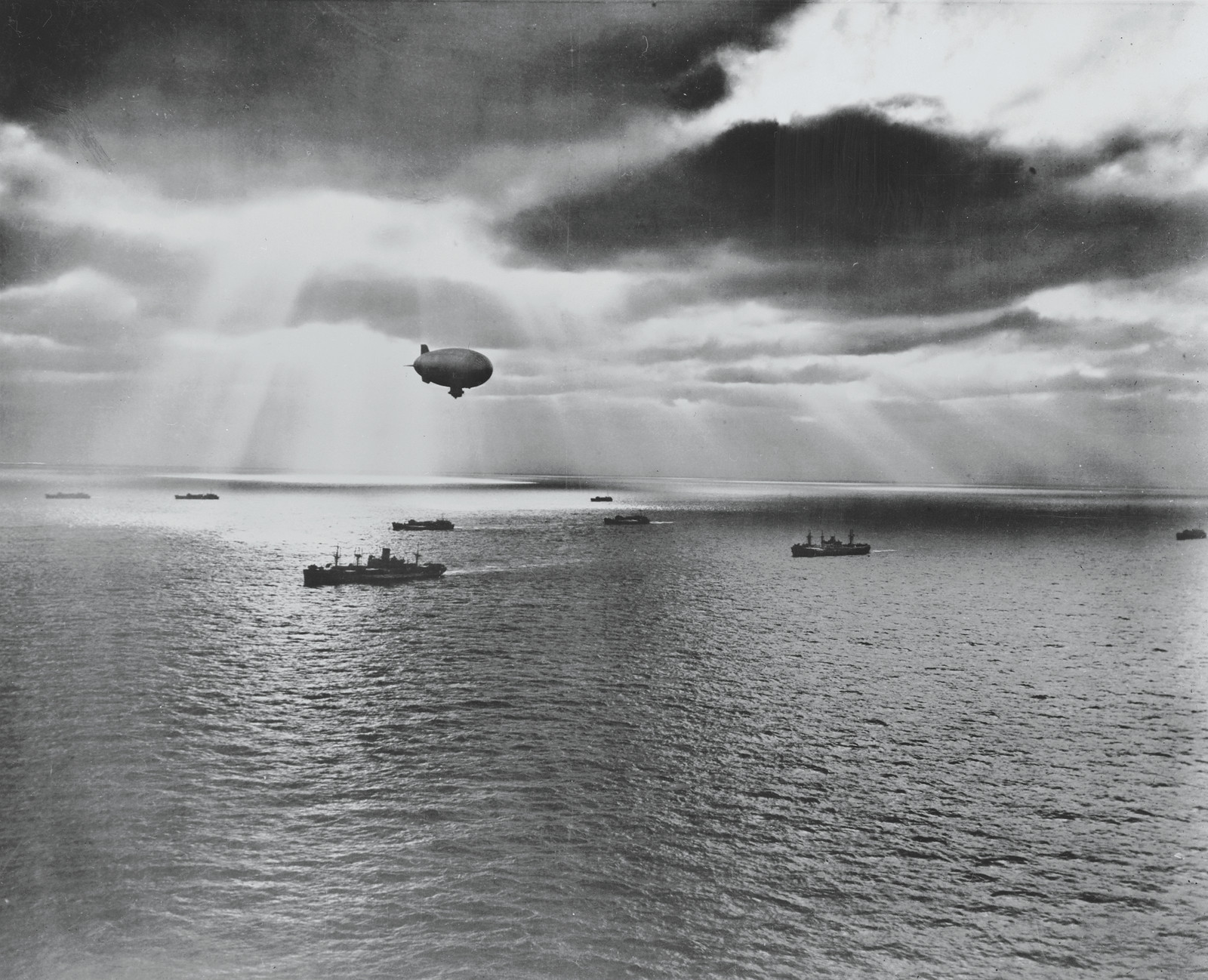 Airship over a convoy of ships at sea — historic image