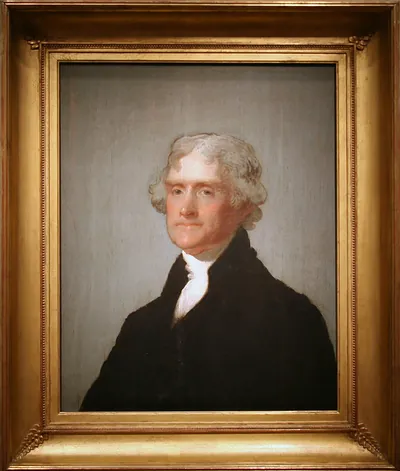 Portrait of a man with white hair in a dark coat
