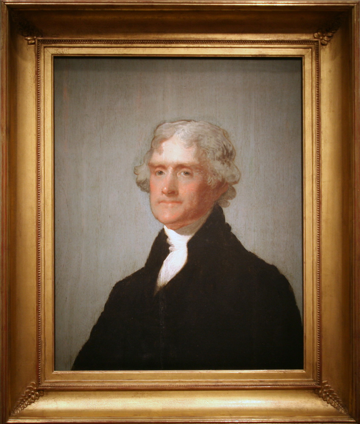 Portrait of a man with white hair in a dark coat — historic image