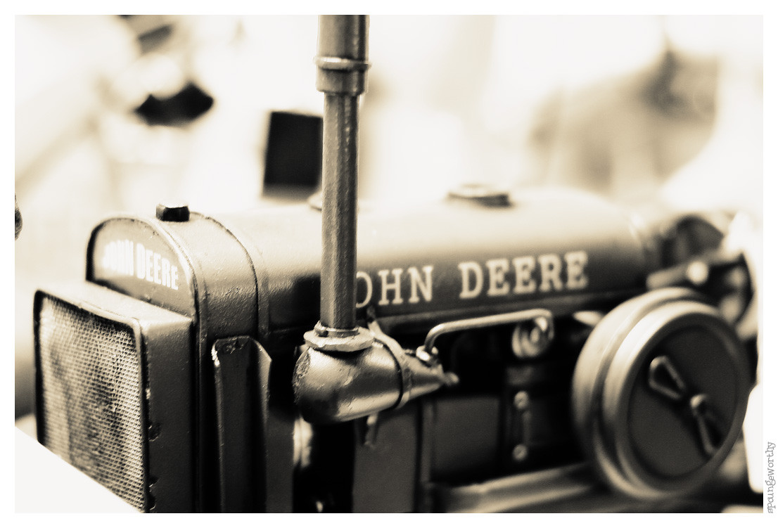 Close-up of a model John Deere tractor in sepia — historic image