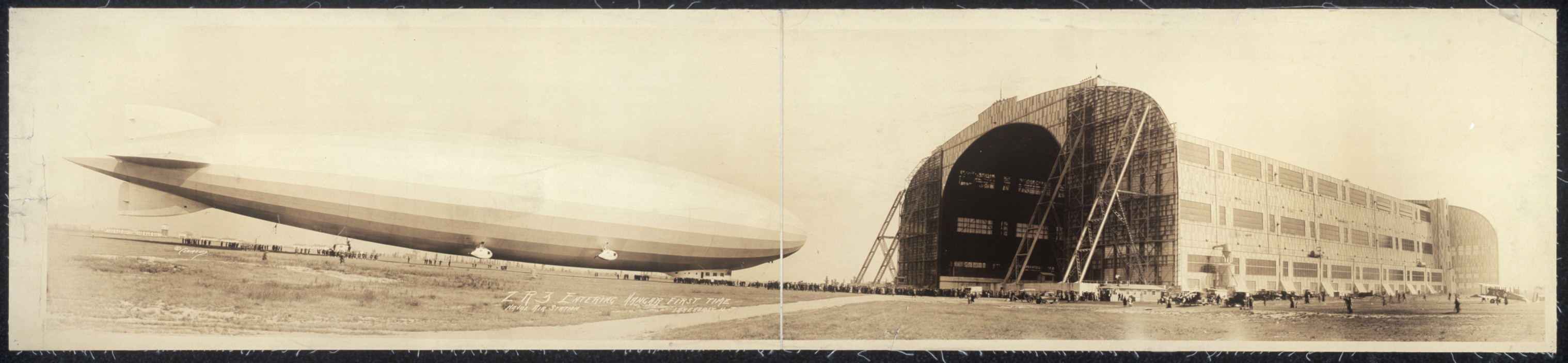 Airship beside large hangar, panoramic photograph — historic photograph
