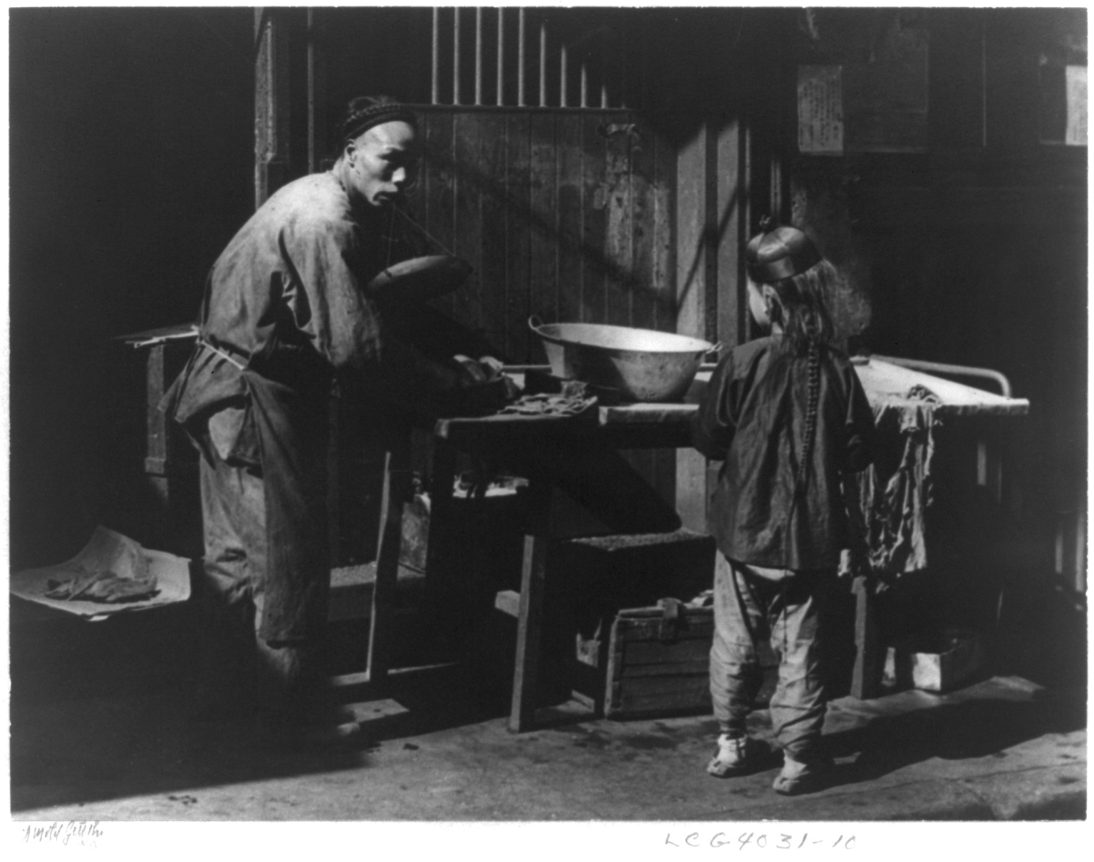 [San Francisco Chinatown, 1895-1900(?): man and boy working at outdoor laundry] — historic photograph