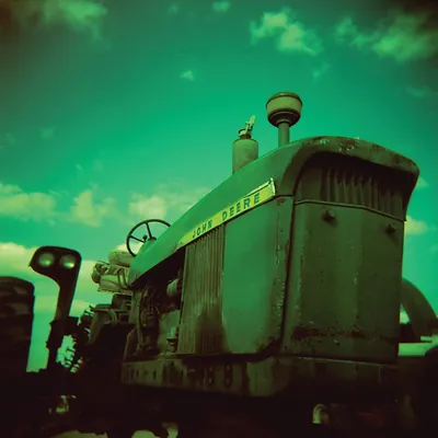 Vintage green John Deere tractor, front view, close-up