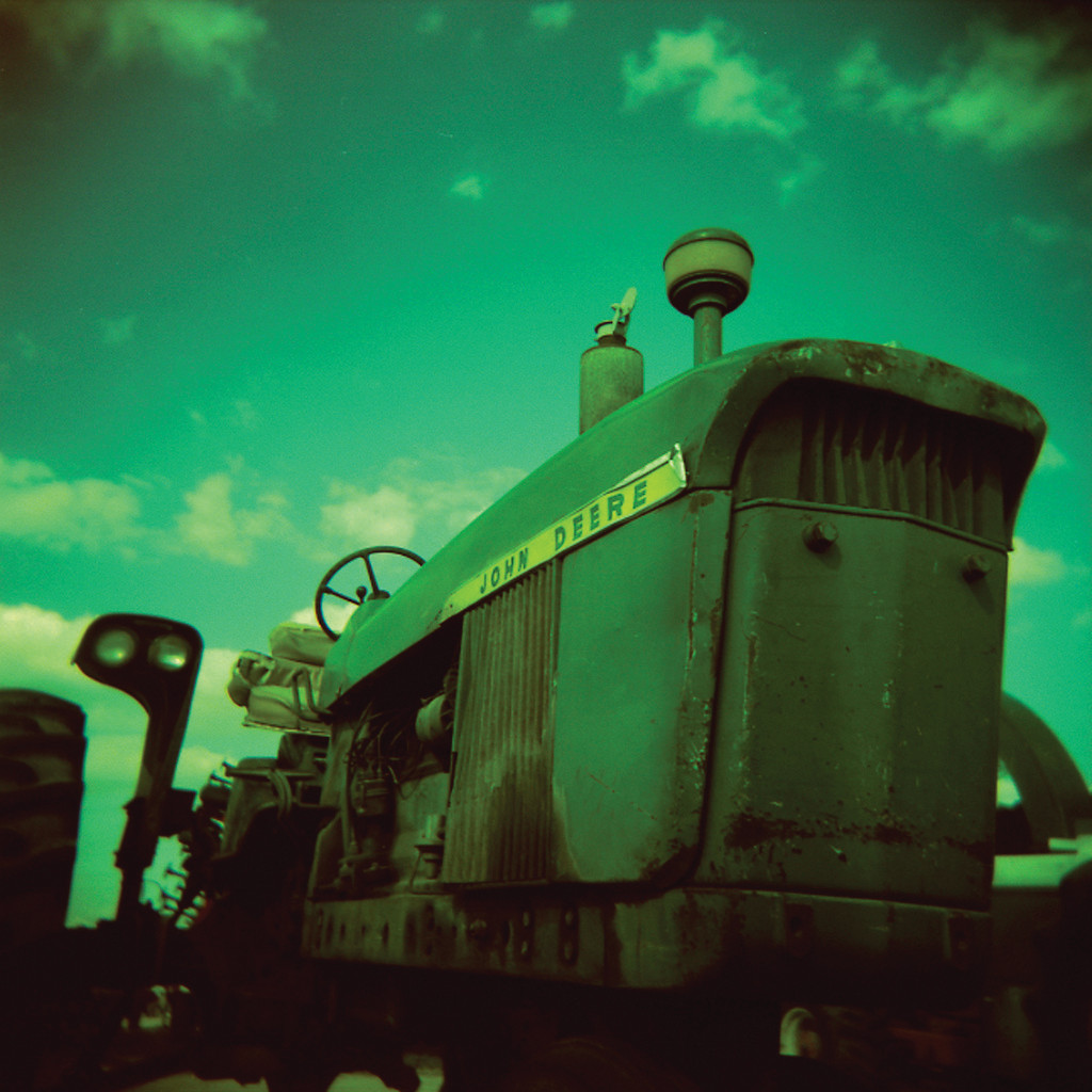 Vintage green John Deere tractor, front view, close-up — historic image