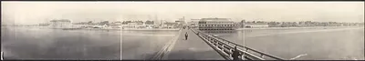 Panoramic photograph of a long pier and waterfront buildings
