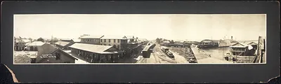 Panoramic view of a Panama waterfront with railway tracks and ship