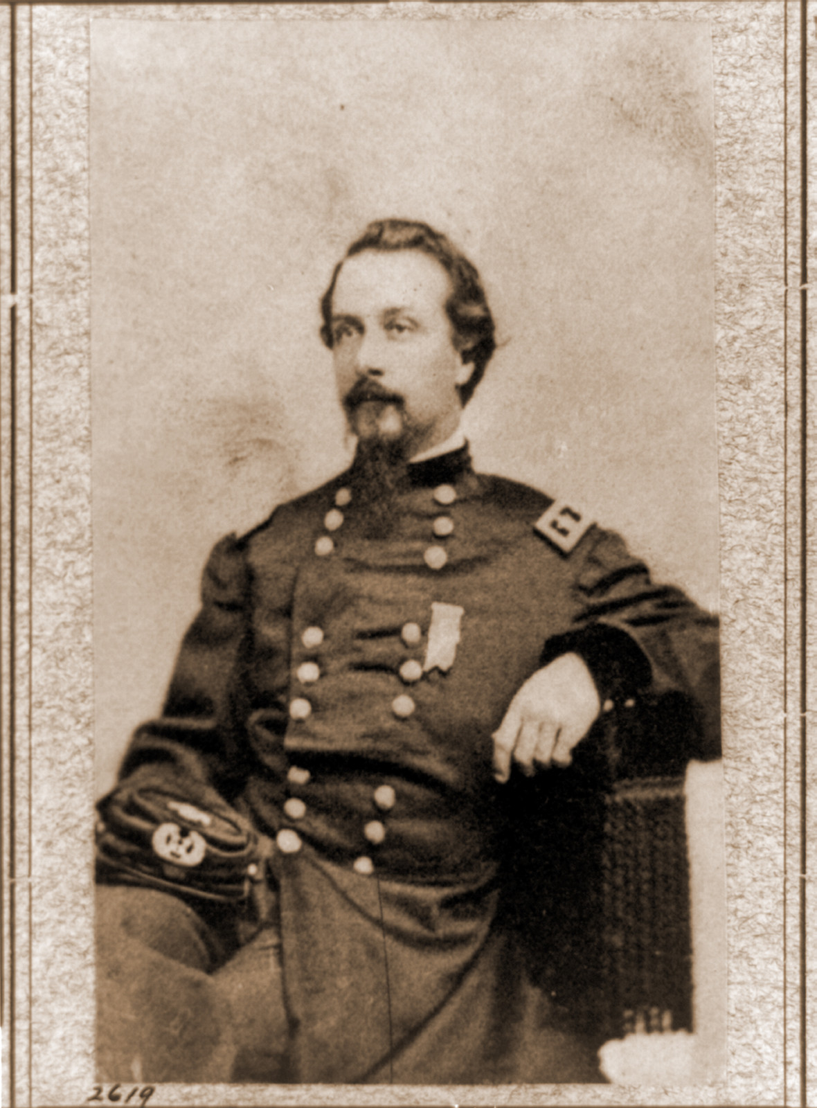 Frank Wheaton three-quarter length portrait seated facing left in uniform, 1861 — historic photograph