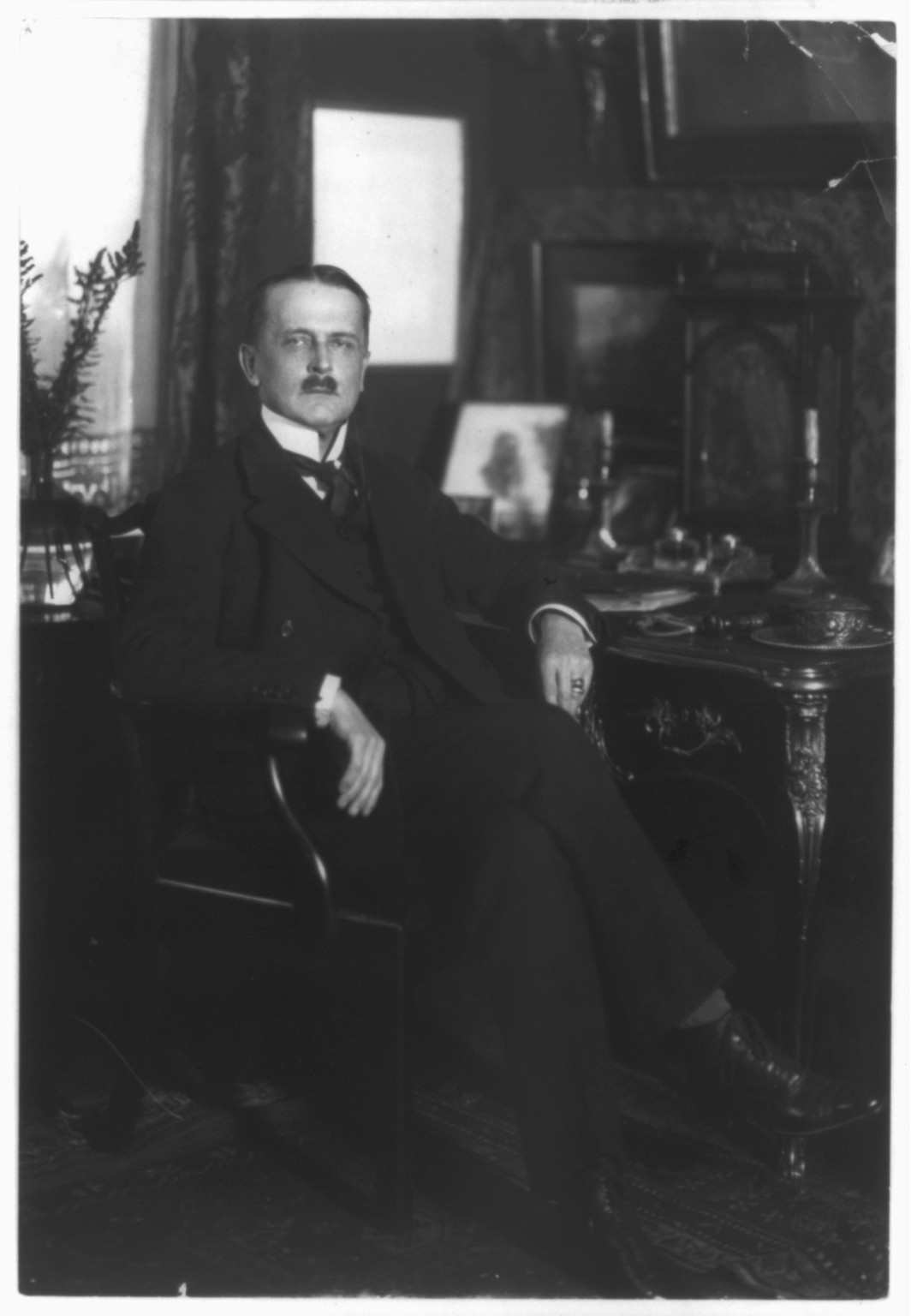 [Count Brockdorff-Rantzau, full-length portrait, seated at desk, facing right], [1924 May] — historic photograph