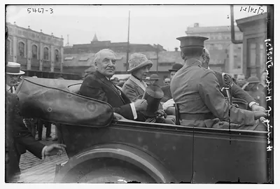 Unidentified man and woman riding in back of car