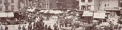 Crowded street market with awnings and horse carts, panoramic photograph