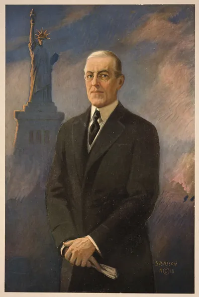 [Woodrow Wilson, half-length portrait, standing, facing left, Statue of Liberty in background]