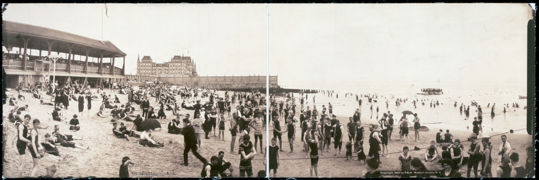 Panoramic beach scene with bathers and seaside pavilion — historic image