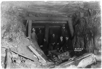 [Men in a coal(?) mine: 7 men in an old working mine shaft]