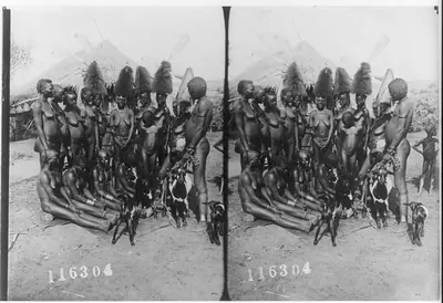 [West Africa, 1909: group of nearly-naked women with several goats]