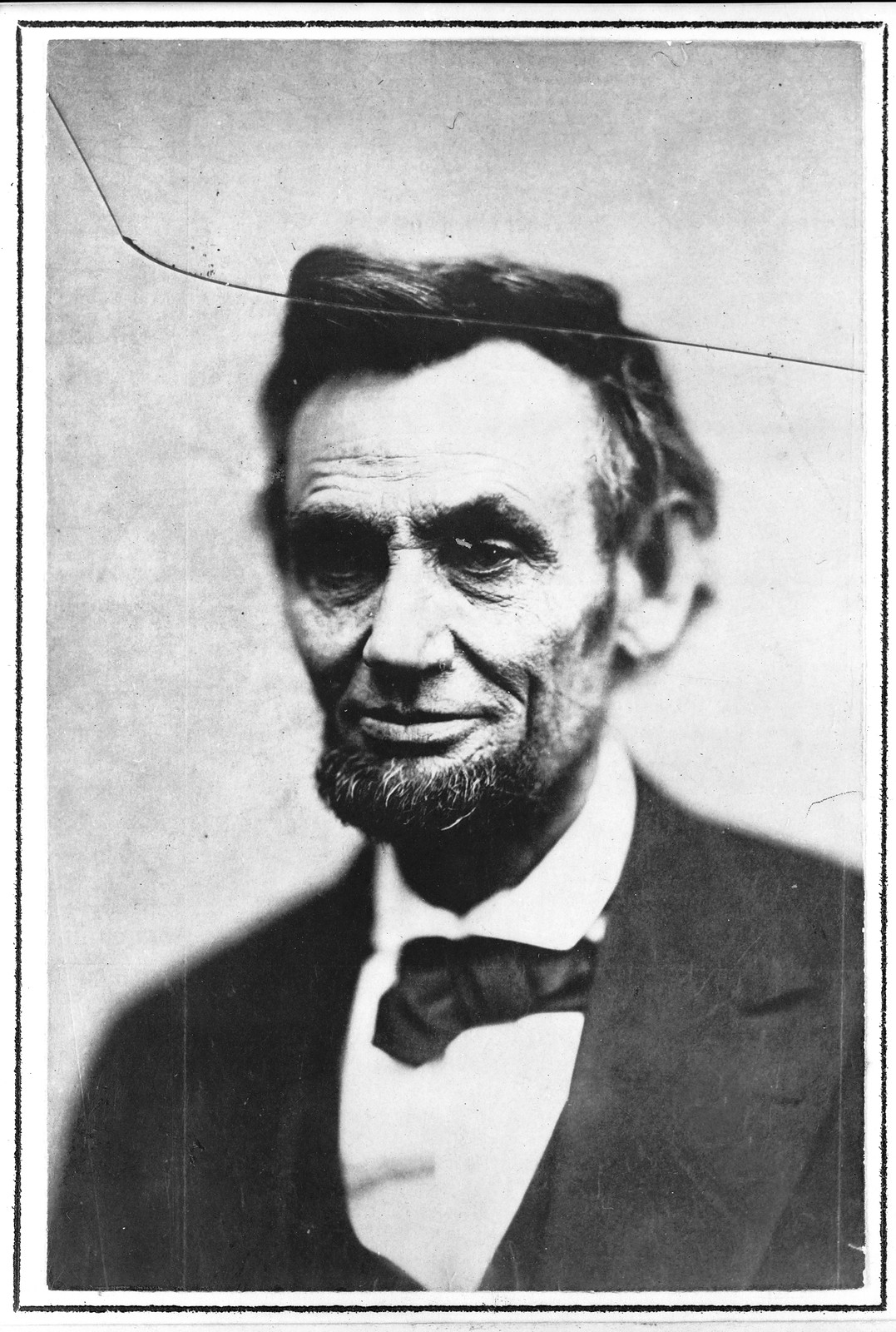 Black and white portrait of a bearded man in suit and bow tie — historic image