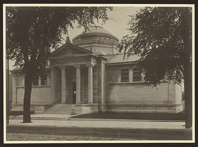 Domed neoclassical library building with columns, photographed from street