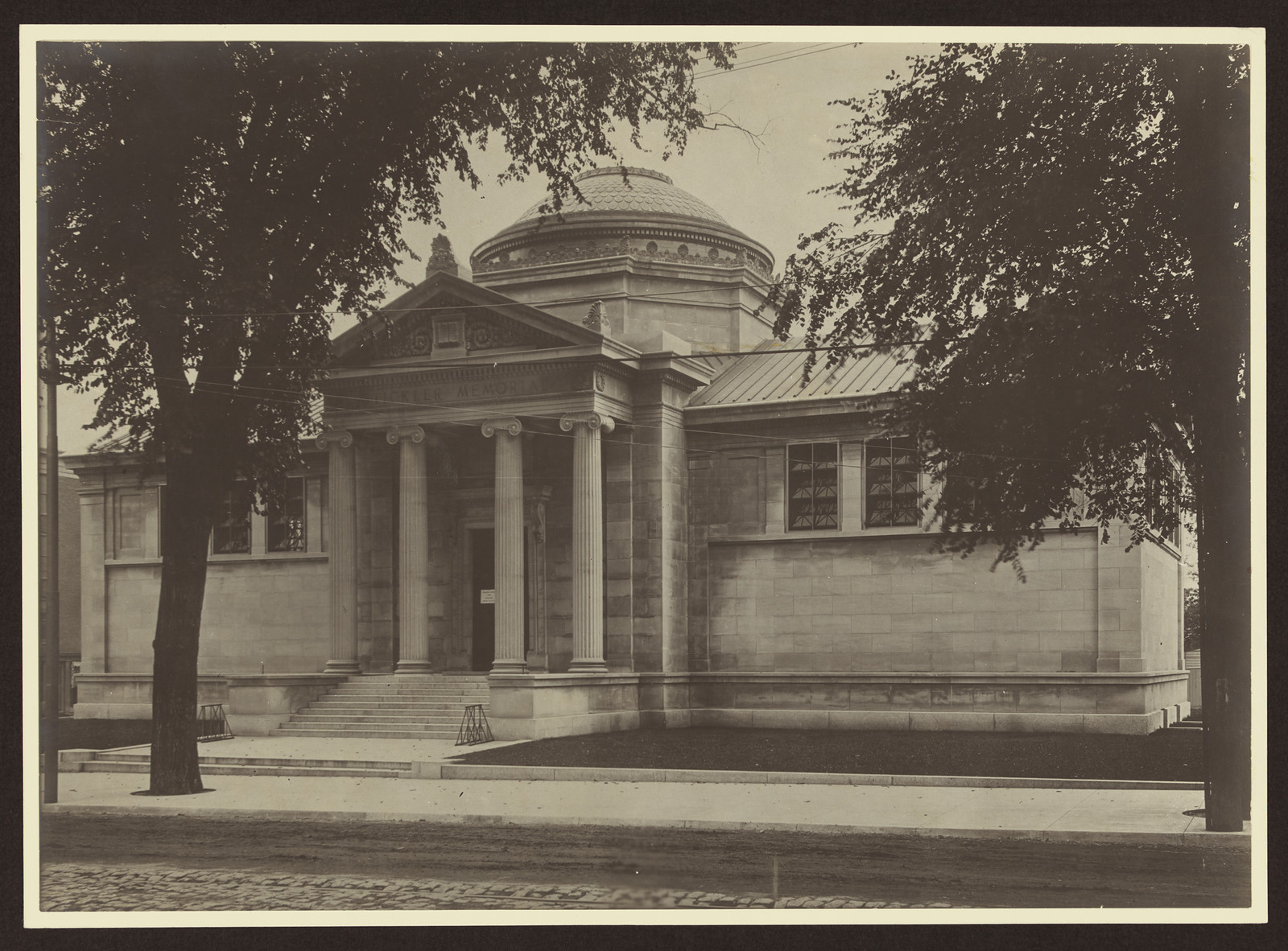 Domed neoclassical library building with columns, photographed from street — historic photograph