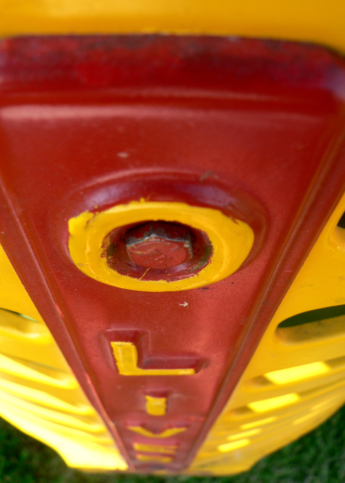 Close-up of red and yellow Oliver tractor emblem with bolt — historic image