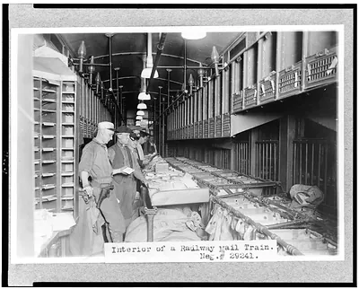 [Men working in a railway mail train]