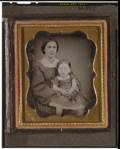 [Unidentified woman and girl, seated, facing front]