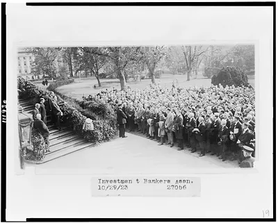 [President Coolidge standing on steps outside the White House, addressing members of the Investment Bankers Association]