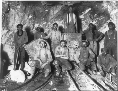 Black, Chinese and White laborers in a gold mine in South Africa
