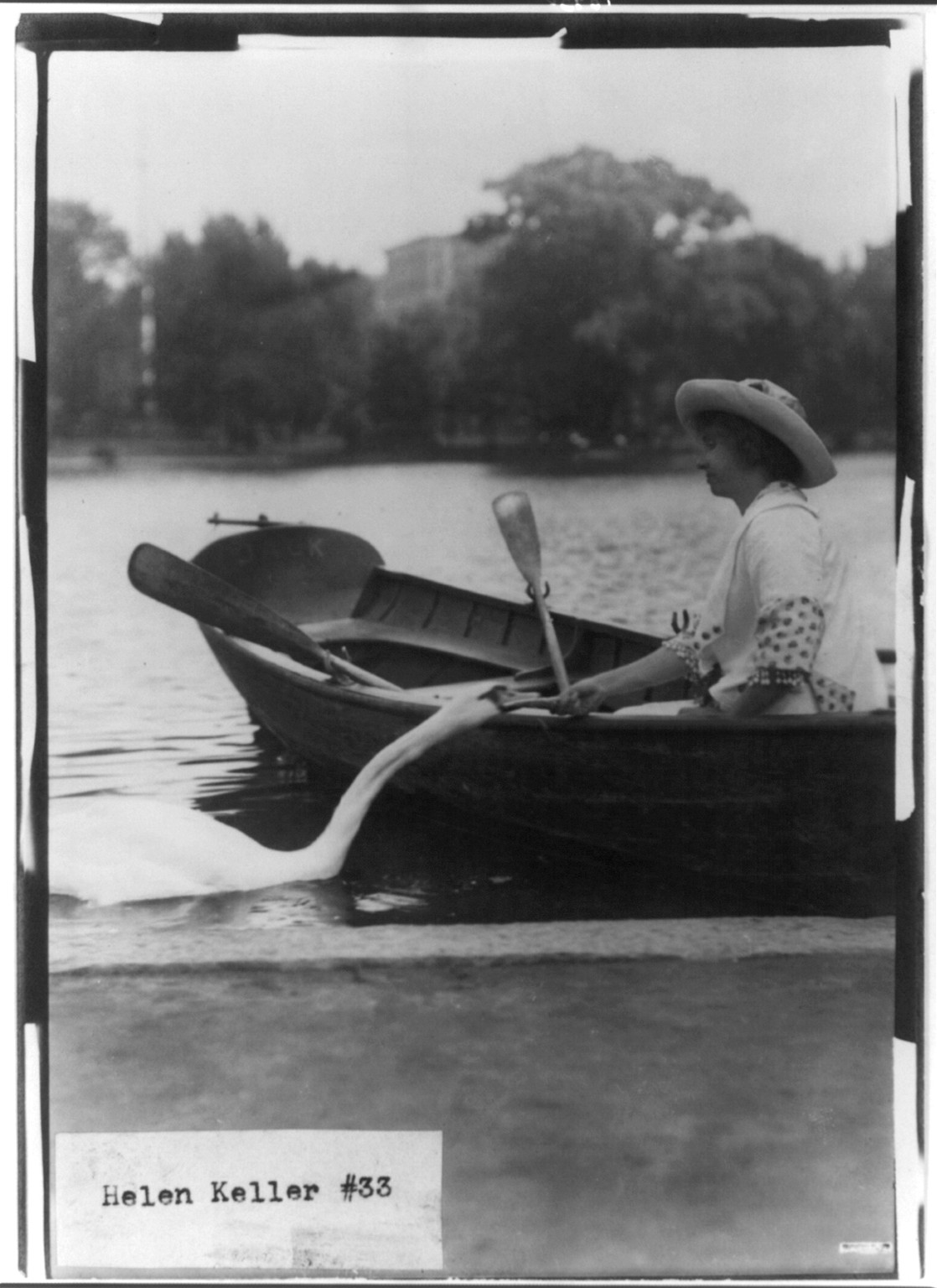 Helen Keller in a boat by shore, c1913. — historic photograph
