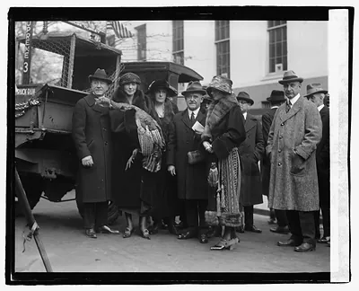 Group of people with a turkey beside a truck